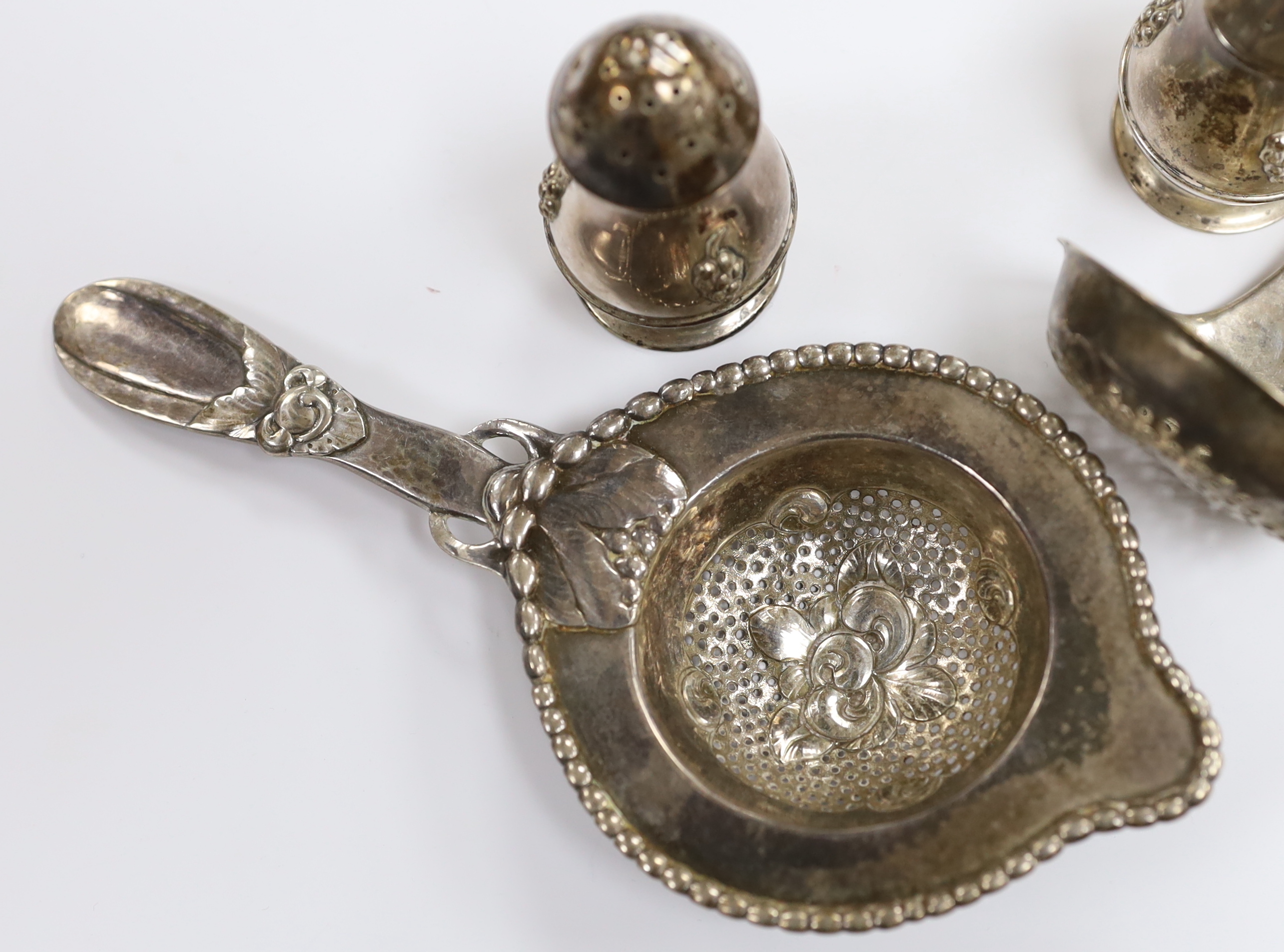 A Danish 830 white metal sifter spoon and tea strainer, by Evald Nielsen and a pair of 1930's Danish white metal condiments.